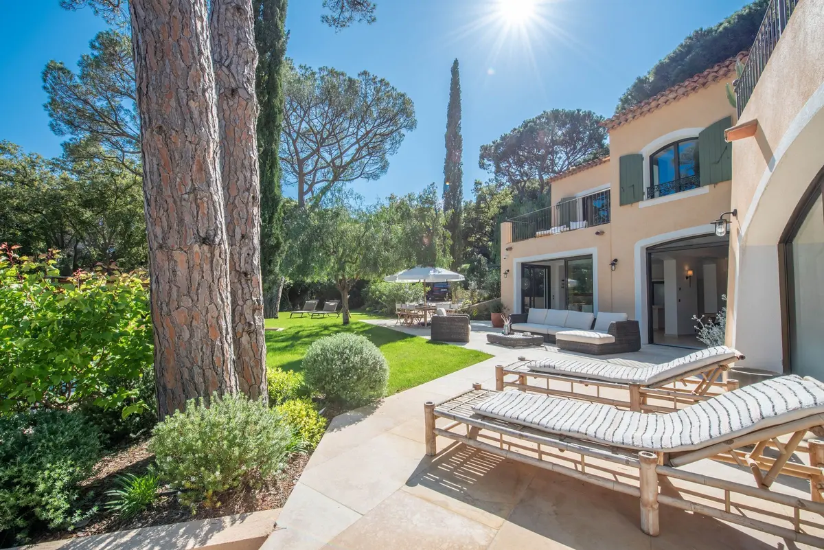 Façade de la villa avec salon extérieur sous les pins